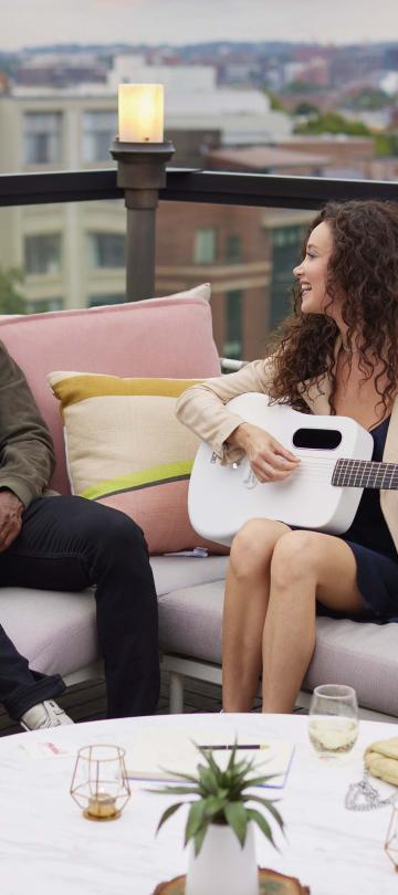 A woman with a guitar serenades her boyfriend at Hush, the rooftop bar at Viceroy Washington DC