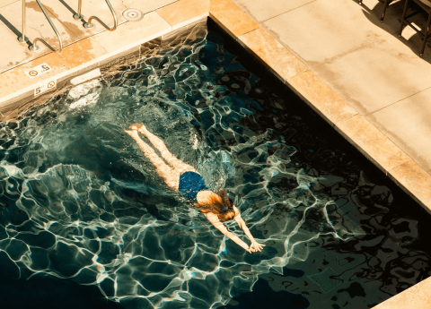 A woman swimming in a pool at Viceroy Snowmass
