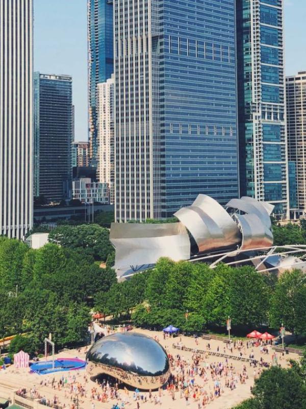 An aerial view of downtown Chicago, with the Bean and numerous large skyscrapers in view