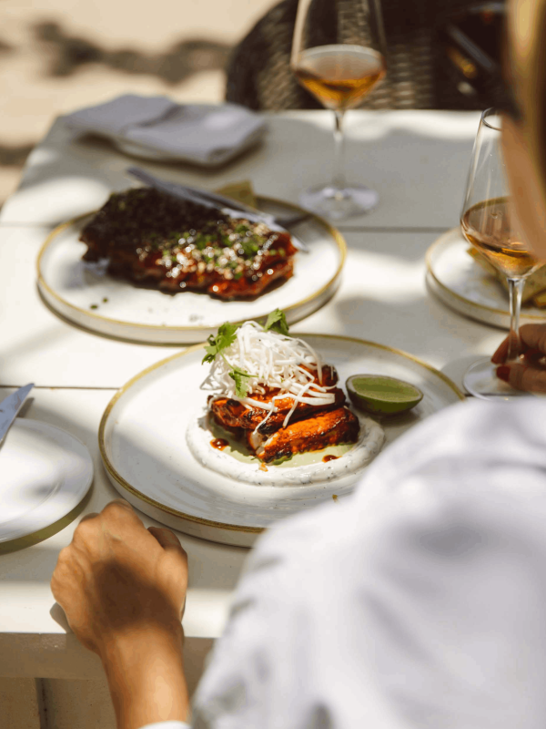 A woman eating a food at Viceroy Sugar Beach