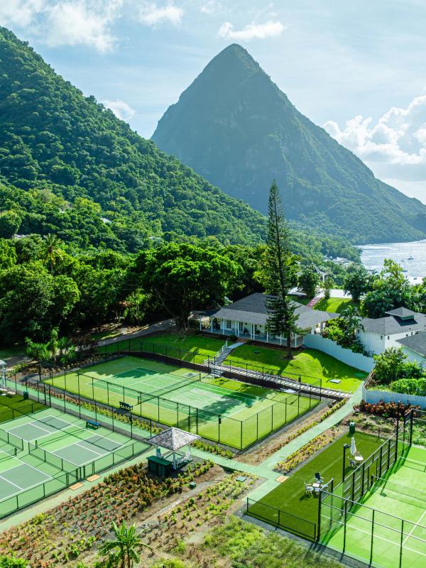 Three racquet courts and a view of the beautiful mountains at Viceroy Sugar Beach