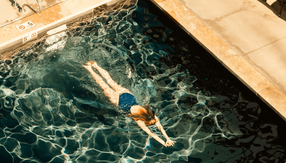 A woman swimming in a pool at Viceroy Snowmass