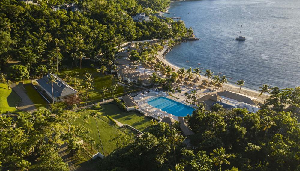 Overhead view of Viceroy Sugar Beach property with the ocean, pools, and green areas