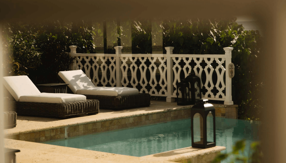Two lounge recliners by the pool at Viceroy Sugar Beach