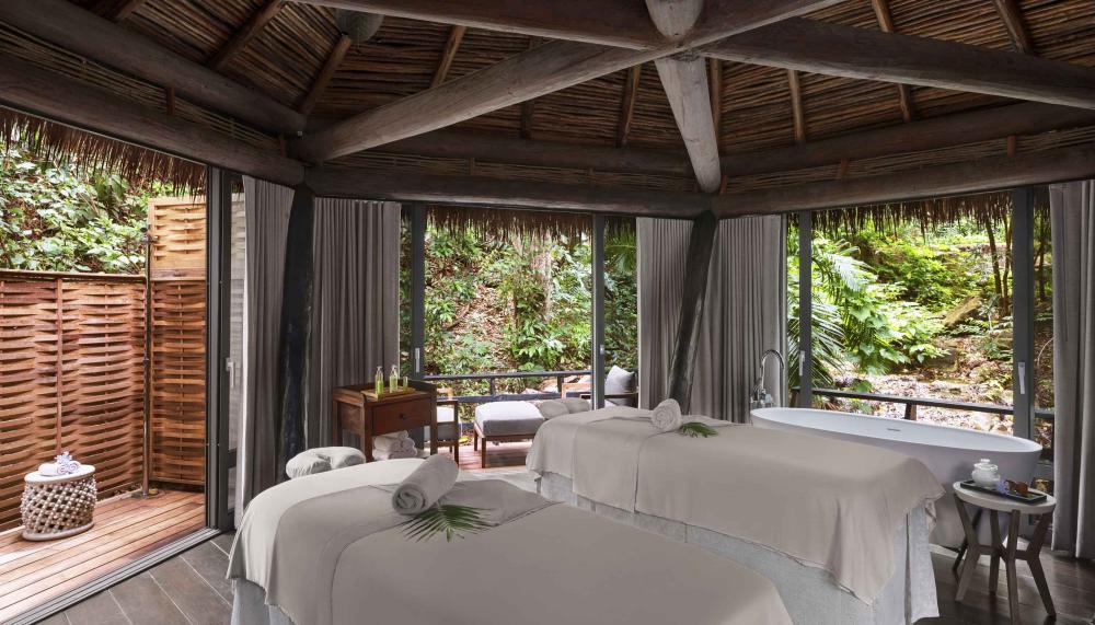 Two massage beds in a hut outside at Viceroy Sugar Beach