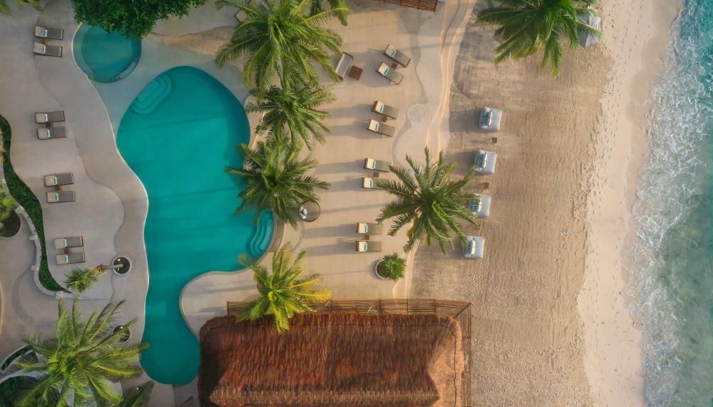 Overhead view of the beach, a pool, and accommodations at Viceroy Riviera Maya