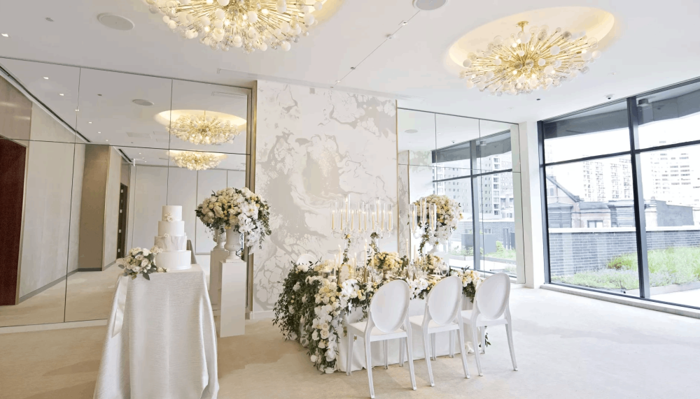 A room with wedding decorations and a table with a wedding cake on it at Viceroy Chicago