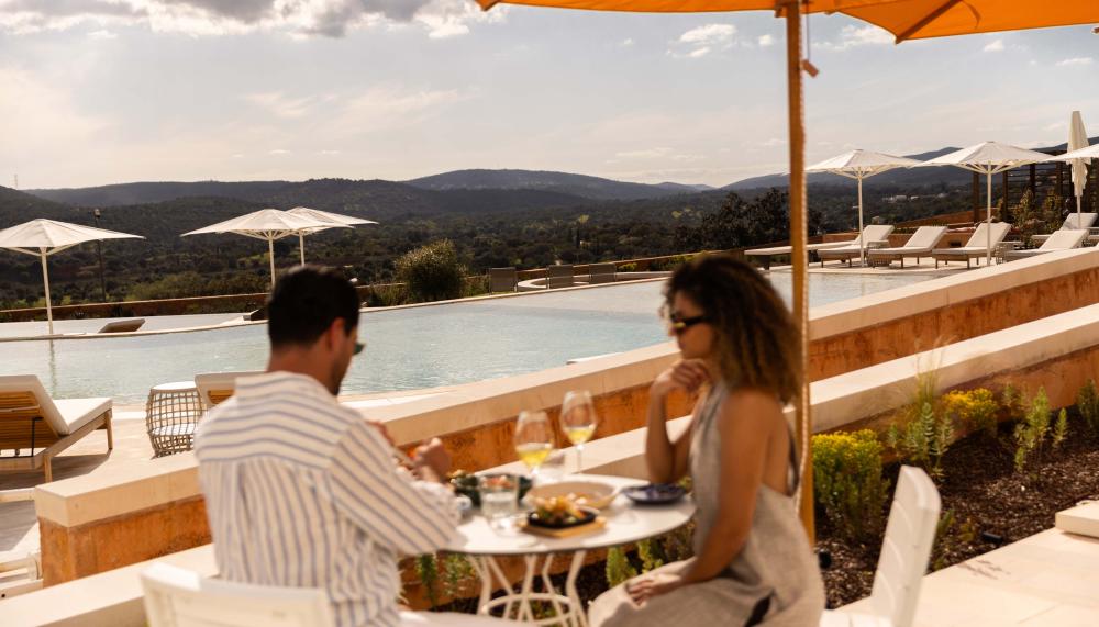 A couple enjoying a lunch on a sunny patio