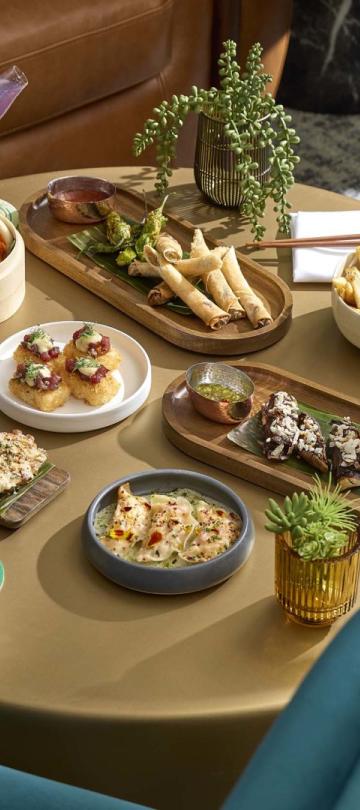 Small plate snacks on an indoor dining table at Pandan
