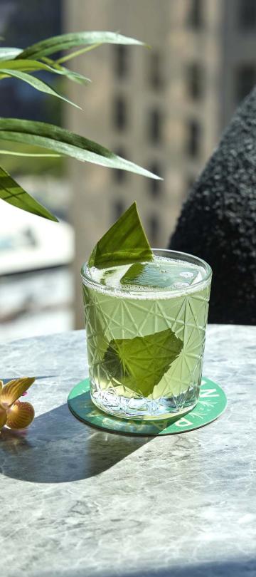 The Pandan cocktail, a green drink with a mint garnish