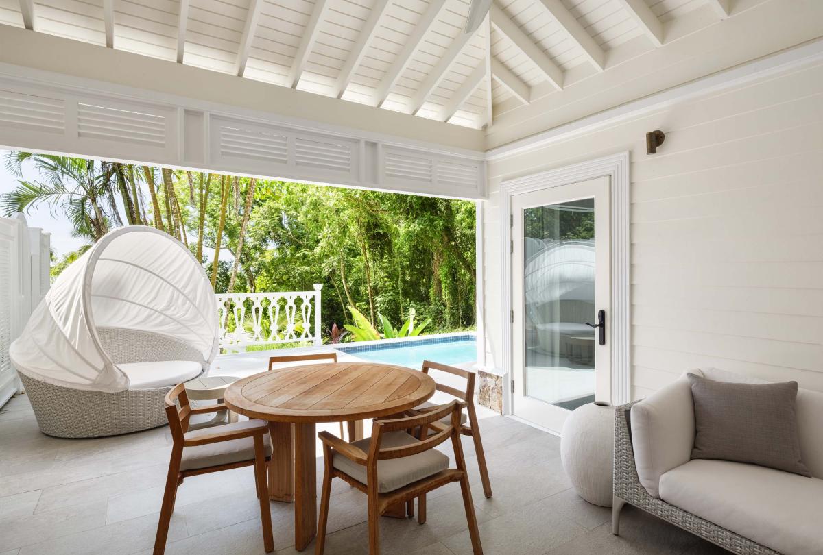 covered patio with dining table and sofa