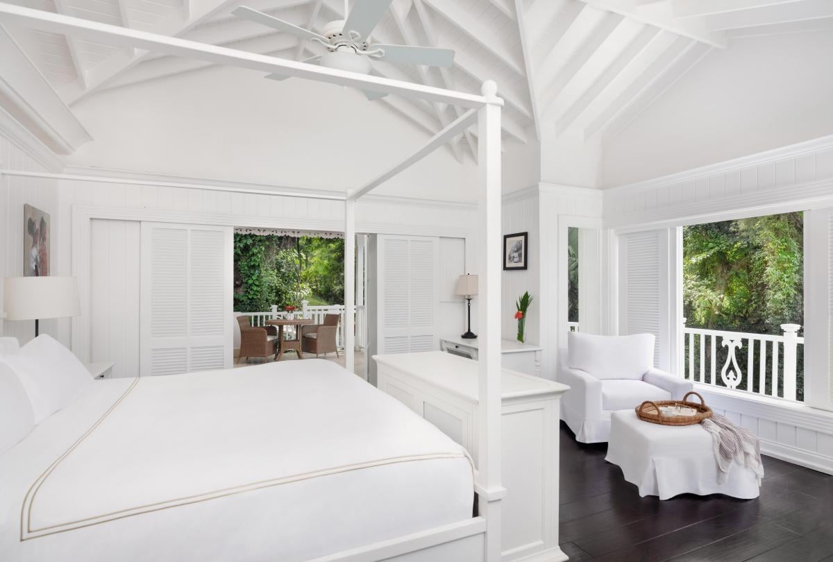 white bedroom with large bed and sitting area