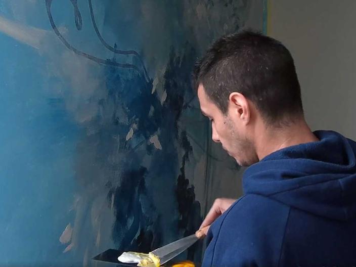 Artist Ognjan Dzevrnja works on a large painting, "The Wild Spirits of Kopaonik Mountain"