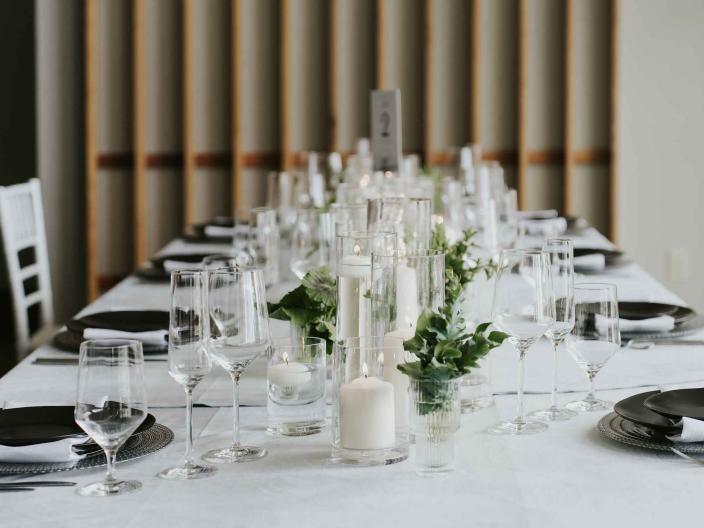 A table setting for a wedding at Viceroy Snowmass, with a white tablecloth and green centerpieces