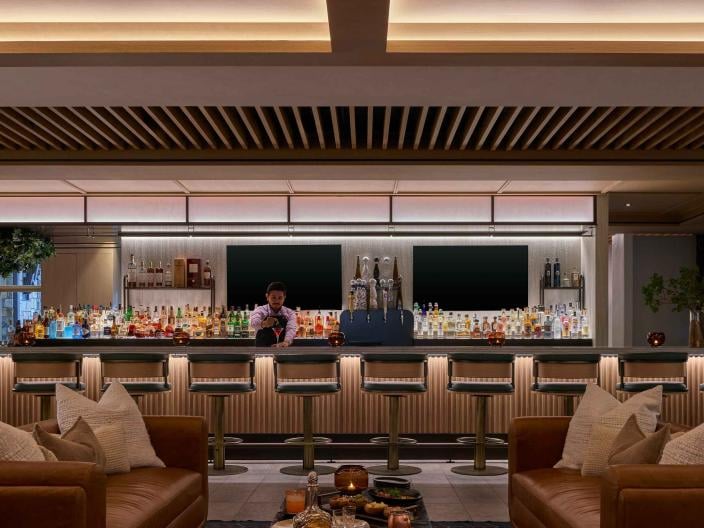 A bartender prepares a cocktail at Viceroy Lounge at Viceroy Snowmass.