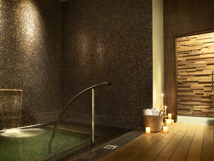 A wading pool at Viceroy Snowmass spa, lit by candles