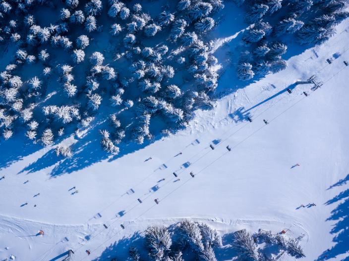 aerial view of chairlift on snow covered mountain