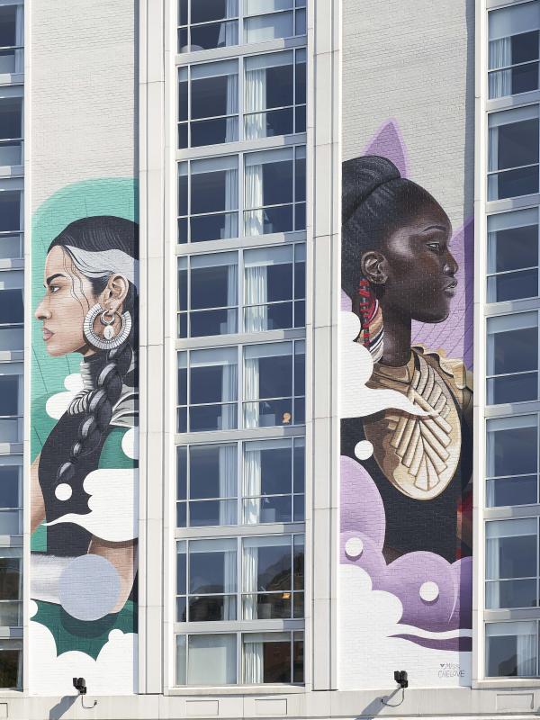A mural of two women painted on the outside of Hotel Zena