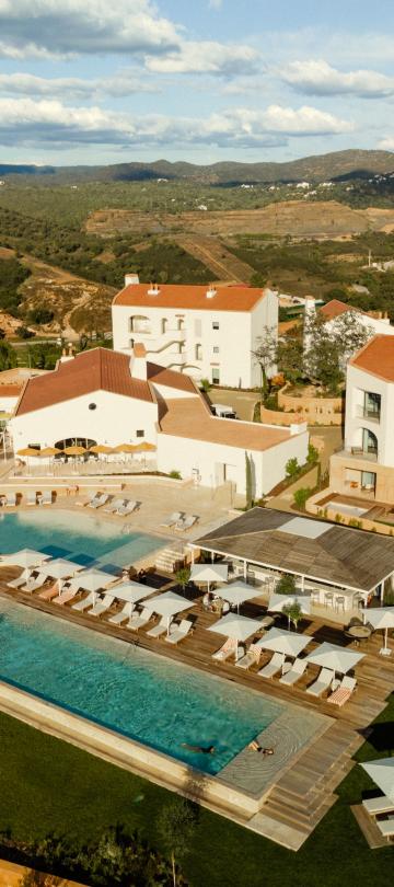 Aerial view of the Viceroy Ombria Algarve, with a pool surrounded by white villas