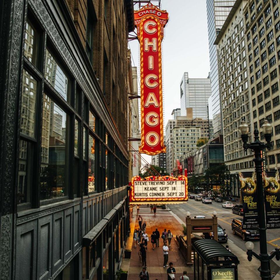 A large vintage neon sign that reads "Chicago" in downtown Chicago