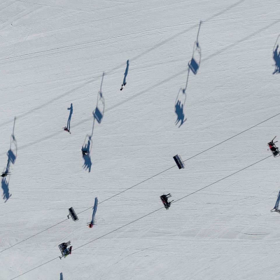 Shadows cast on the snow from a ski lift overhead at Viceroy Snowmass