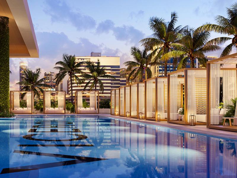 The pool and cabanas, lined with palm tree, at the Viceroy Residences at Fort Lauderdale