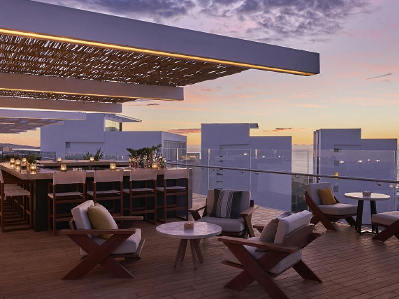 A rooftop patio at sunset, at Viceroy Los Cabos
